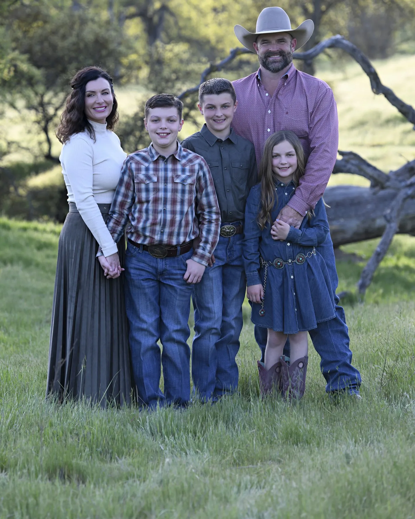 Dr. Kaci with her husband Dustin and their children Baron, Ellis, and Blythe in a grassy oak meadow